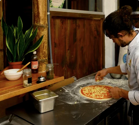A Rivel chef preparing pizza